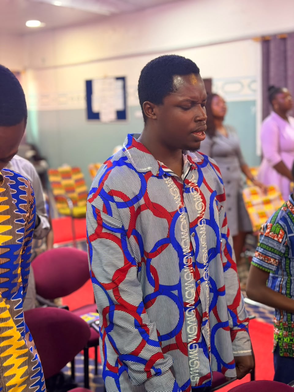 A young man in prayer during worship