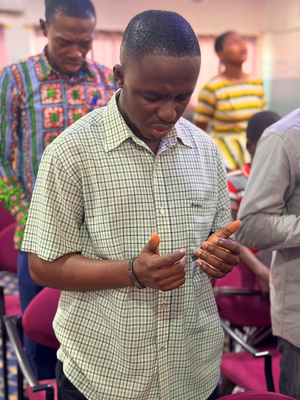 A member praying with open hands