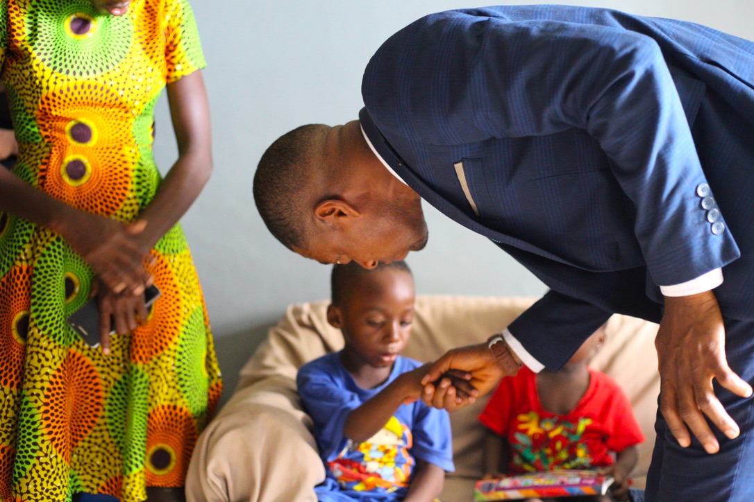 A ministry member greeting a young boy during an orphanage visit